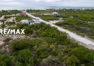 Overhead view of a 100x100 roadfront lot for sale at Secret Beach, showcasing its spacious layout and proximity to the beach