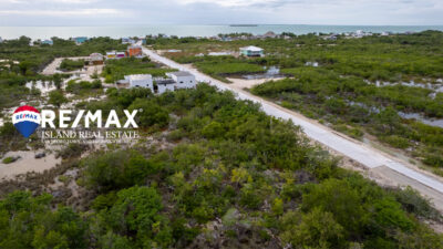 Overhead view of a 100x100 roadfront lot for sale at Secret Beach, showcasing its spacious layout and proximity to the beach