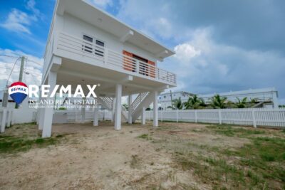 Front view of a newly built 2-bedroom concrete home in San Pedro, Belize, featuring a modern design and welcoming entrance