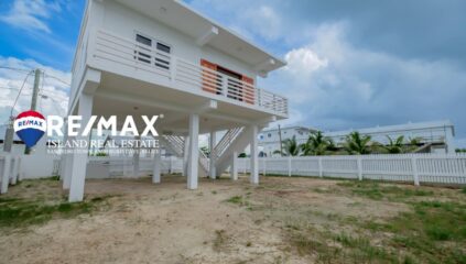 Front view of a newly built 2-bedroom concrete home in San Pedro, Belize, featuring a modern design and welcoming entrance