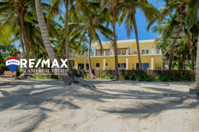 Front view of beachfront property on Ambergris Caye, showcasing the home with stunning Caribbean Sea views and lush tropical surroundings