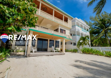 View of Emeralda Lodge condo building from the ocean, located on a beachfront property in San Pedro, with direct access to the beach