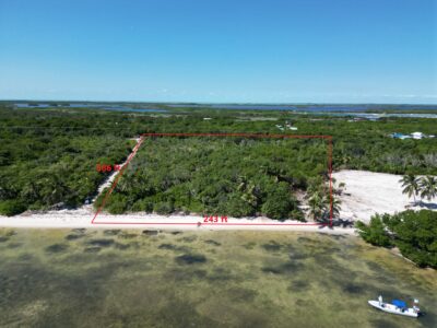 Aerial view of beachfront land in San Andres, Ambergris Caye, with outlined lot area showing 243' oceanfront and 586' depth, highlighting the property's prime location