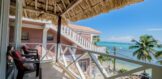 Panoramic view from the porch of an oceanfront condo in San Pedro, Ambergris Caye, with sweeping vistas of the Caribbean Sea and Belize Barrier Reef.