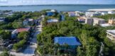 Aerial view of two side-by-side Ambergris Caye canal lots for sale, showcasing their prime location with easy access to the reef and surrounding island features